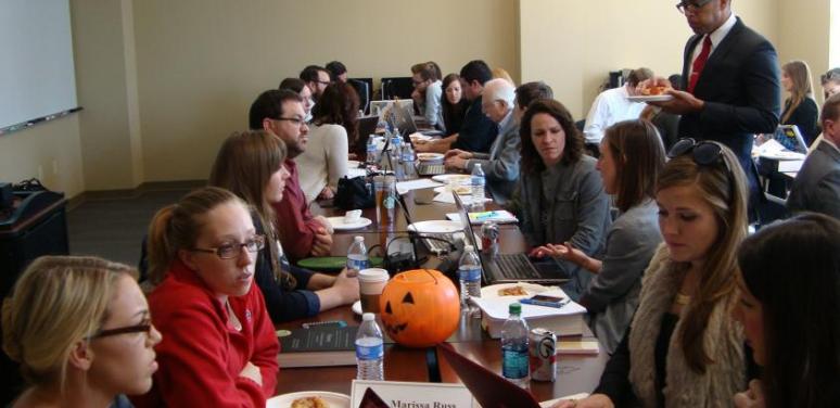 Group of people working around conference table
